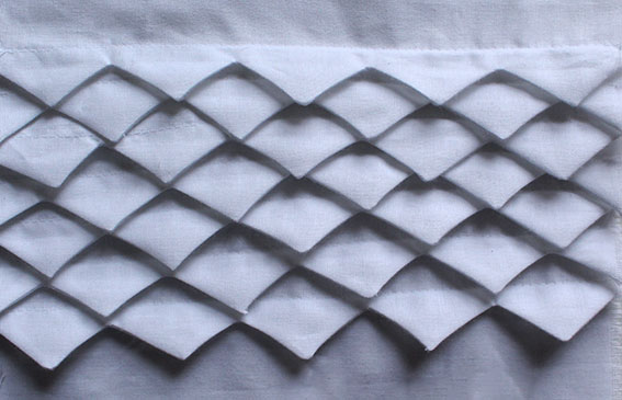 manipulate fabric with contoured tucks
