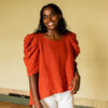 Calendula shirt made in orange linen on a model. Photo by Laura Oja.