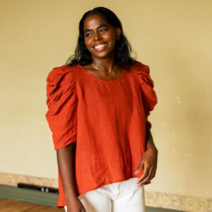 Calendula shirt made in orange linen on a model. Photo by Laura Oja.