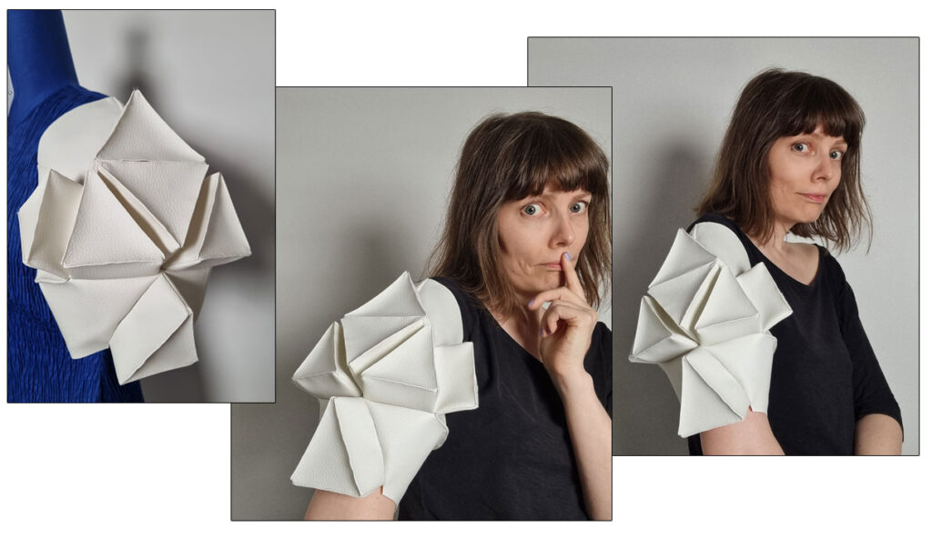 The white faux leather sleeve with sculptural triangles is ready