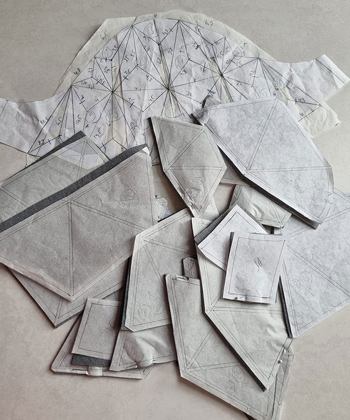 The polyhedron pieces and the original draft.