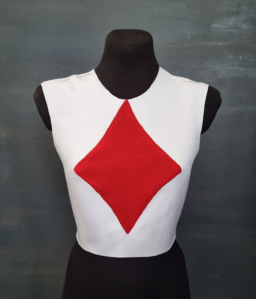 White top with a red diamond shape in the front.