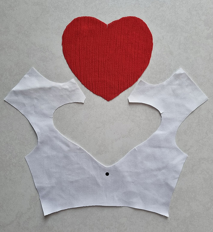 The bodice and the heart shape cut.
