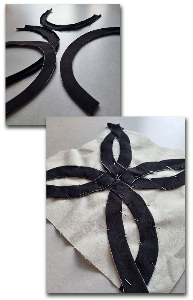 The fabric strips pressed and pinned onto the bodice back.