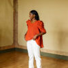Model wearing the orange Calendula blouse. Photo by Laura Oja.
